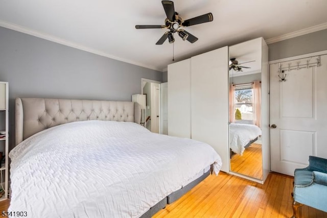 bedroom with a ceiling fan, light wood-type flooring, and crown molding