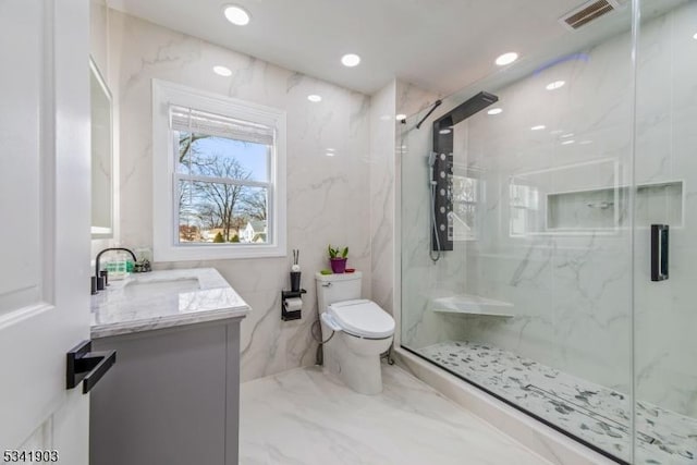 bathroom with marble finish floor, a marble finish shower, visible vents, toilet, and vanity