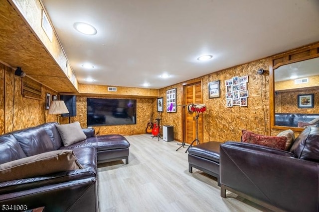 living area featuring recessed lighting, visible vents, and wood finished floors