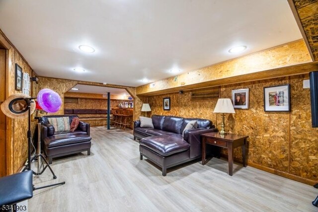 living area with light wood-type flooring and recessed lighting