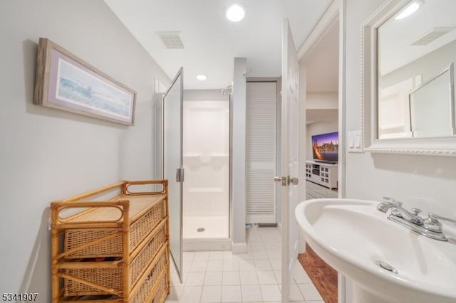 full bathroom with a stall shower, a sink, visible vents, and tile patterned floors