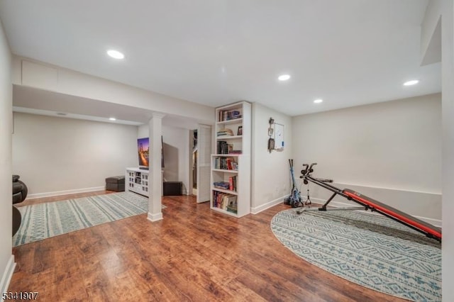 exercise room featuring recessed lighting, wood finished floors, and baseboards