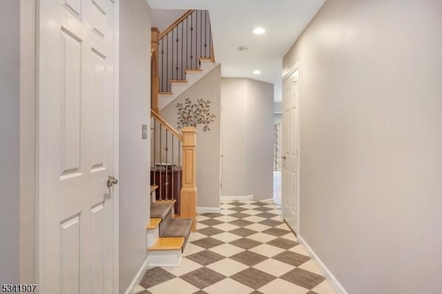 hallway featuring stairs, light floors, recessed lighting, and baseboards