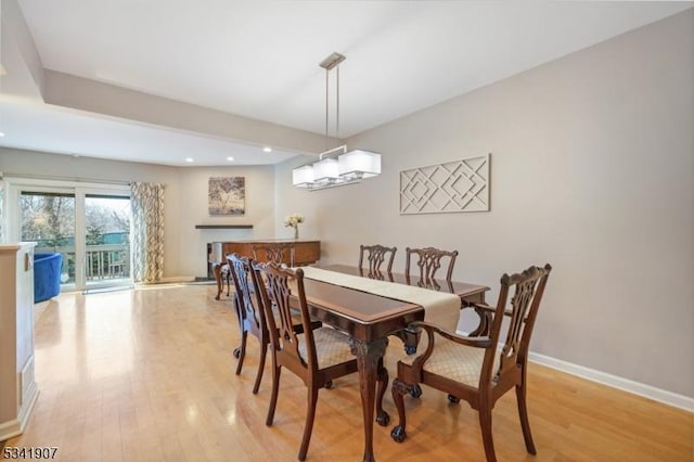 dining area with baseboards, recessed lighting, and light wood-style floors