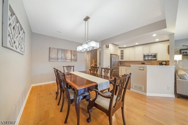 dining area featuring recessed lighting, baseboards, visible vents, and light wood finished floors