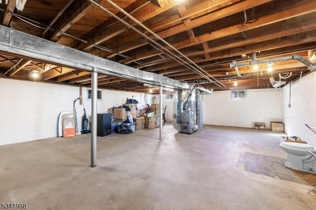 unfinished basement featuring heating unit