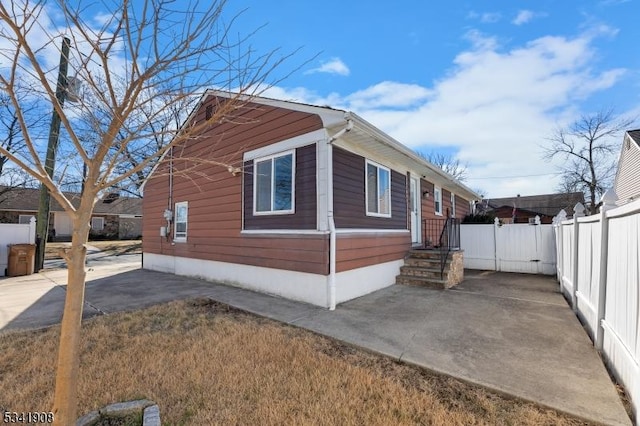 view of property exterior featuring fence