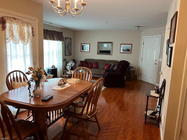 dining area with an inviting chandelier and wood finished floors