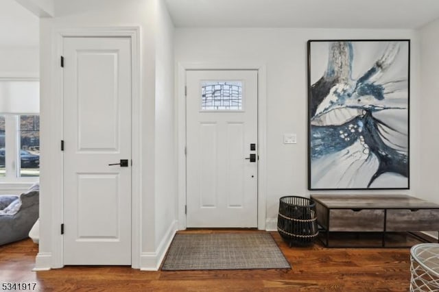 entrance foyer with wood finished floors and baseboards