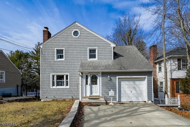 view of front of home featuring a shingled roof, driveway, a chimney, and an attached garage