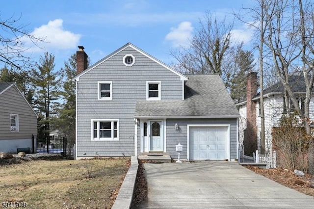 traditional-style home with an attached garage, a shingled roof, fence, concrete driveway, and a chimney