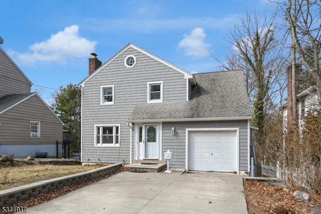 traditional-style house featuring driveway, a shingled roof, a chimney, and an attached garage