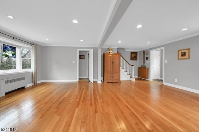 unfurnished living room featuring light wood-style flooring, recessed lighting, baseboards, stairway, and radiator