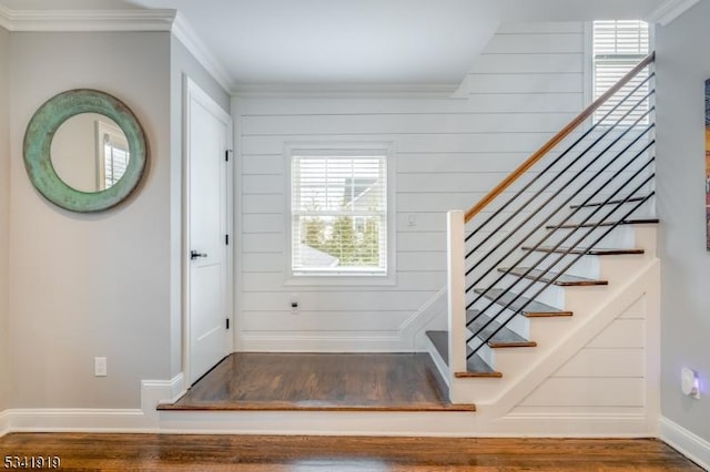 foyer entrance with baseboards, stairway, wood finished floors, and crown molding