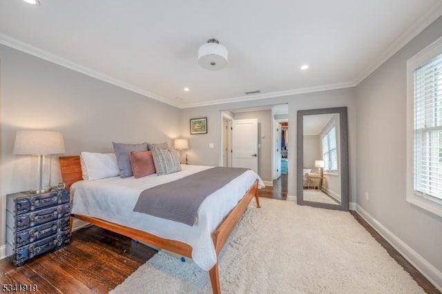 bedroom featuring recessed lighting, baseboards, crown molding, and wood finished floors