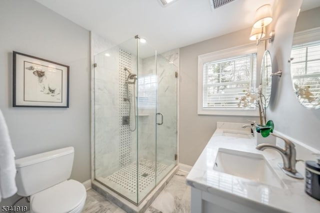 full bath with baseboards, a sink, a shower stall, and toilet