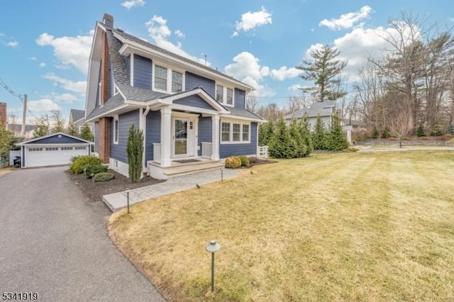 view of front of house featuring a detached garage, a chimney, a shingled roof, a front yard, and an outdoor structure