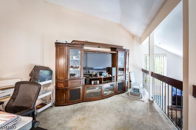 carpeted office space with vaulted ceiling