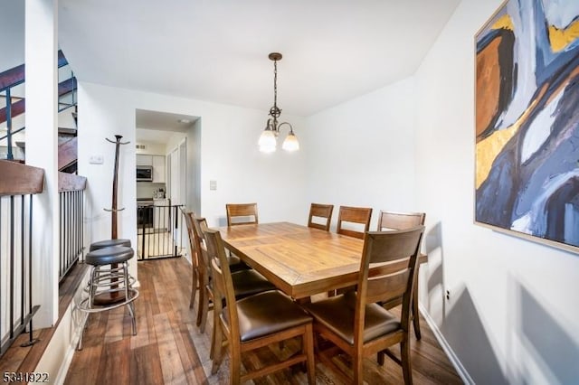 dining area featuring baseboards and wood finished floors