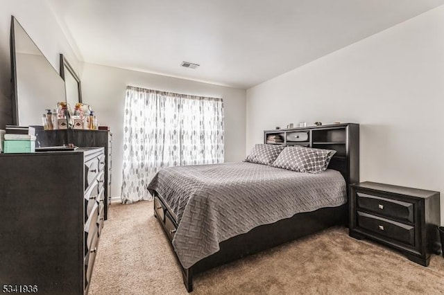 bedroom with light carpet and visible vents