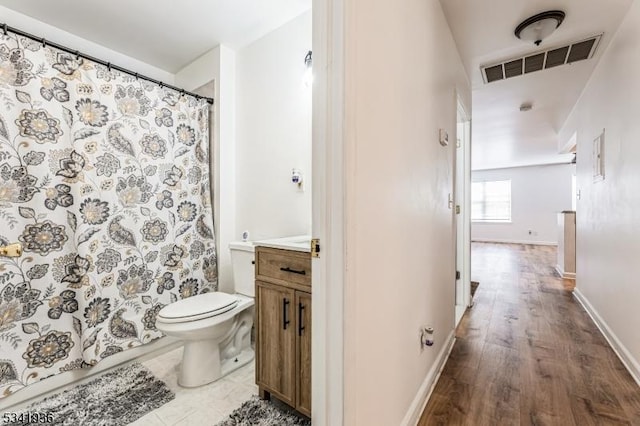 full bathroom with baseboards, visible vents, toilet, wood finished floors, and vanity