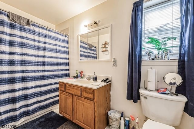 full bath featuring toilet, a shower with curtain, and vanity