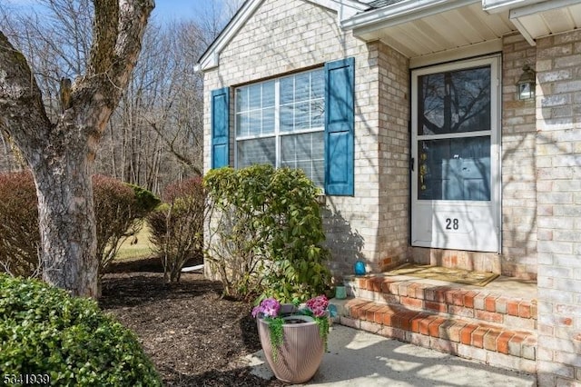 property entrance featuring brick siding