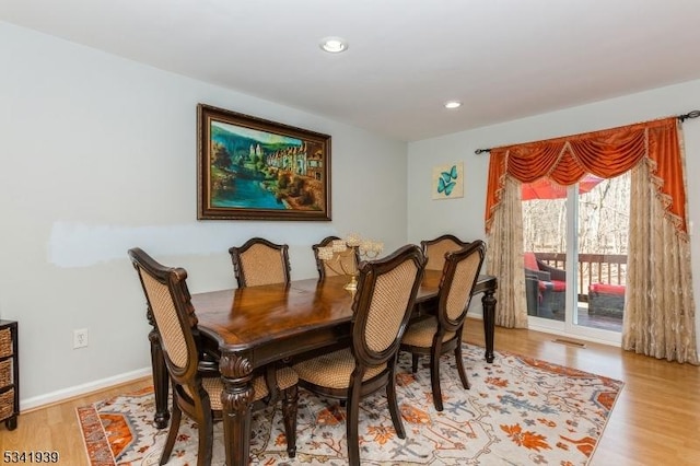 dining room with baseboards, light wood-type flooring, visible vents, and recessed lighting