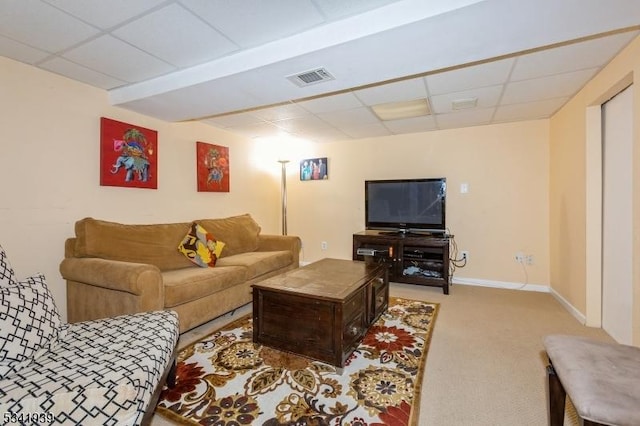 carpeted living area with a drop ceiling, visible vents, and baseboards