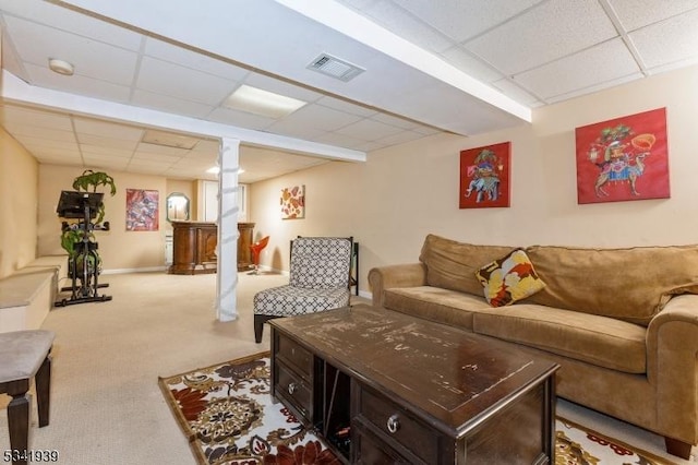 carpeted living area featuring baseboards, visible vents, and a drop ceiling