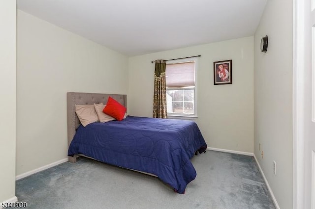 bedroom with carpet flooring and baseboards