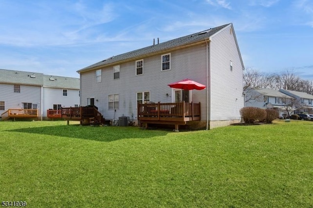 back of property featuring cooling unit, a lawn, and a wooden deck