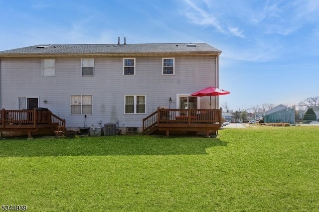 back of house featuring a deck, central AC, and a yard