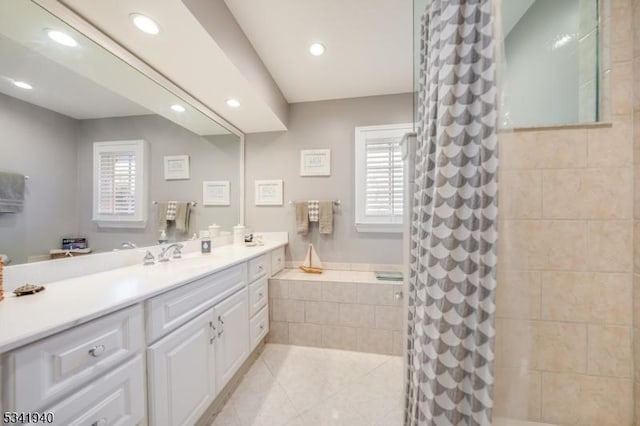 bathroom with curtained shower, plenty of natural light, tile patterned flooring, and vanity