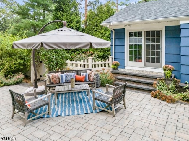 view of patio featuring an outdoor hangout area and fence