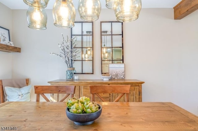 dining space featuring beam ceiling