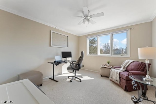 carpeted home office with a ceiling fan, baseboards, and ornamental molding