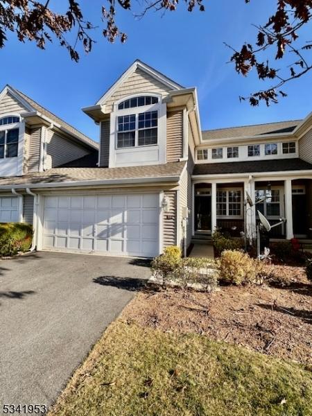 view of front of house with aphalt driveway and a garage