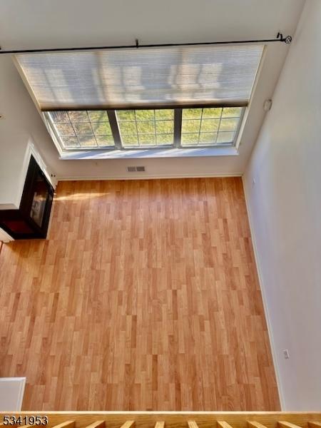 unfurnished room featuring baseboards and wood finished floors