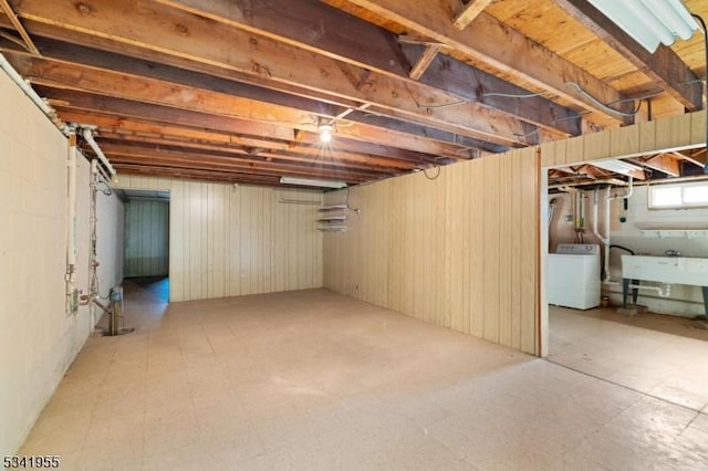 basement with washer / dryer, tile patterned floors, and a sink