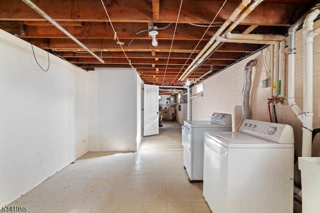 washroom with washer and clothes dryer, laundry area, and a sink