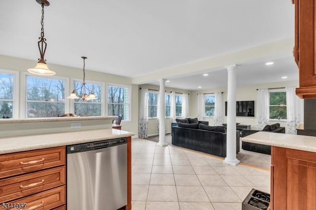 kitchen with light tile patterned flooring, light countertops, dishwasher, brown cabinetry, and decorative columns