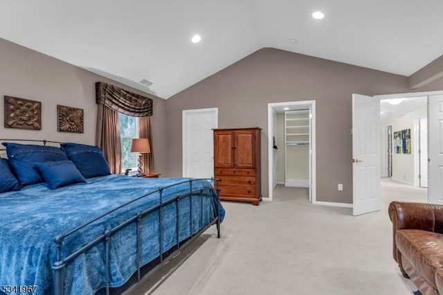 bedroom with light carpet, visible vents, baseboards, lofted ceiling, and a spacious closet