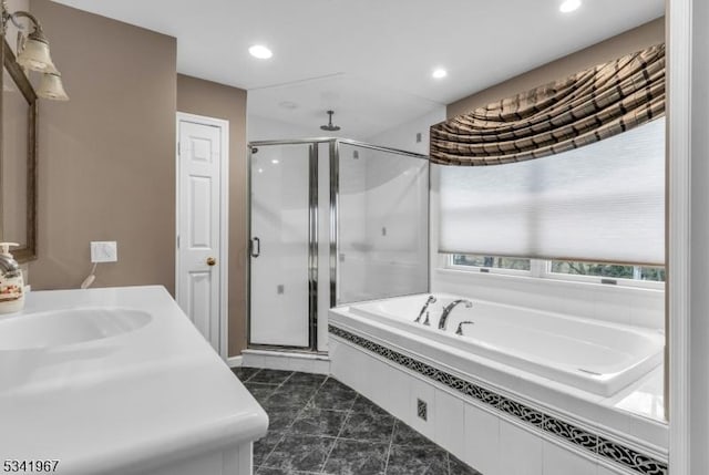 bathroom featuring a garden tub, a shower stall, a sink, and recessed lighting