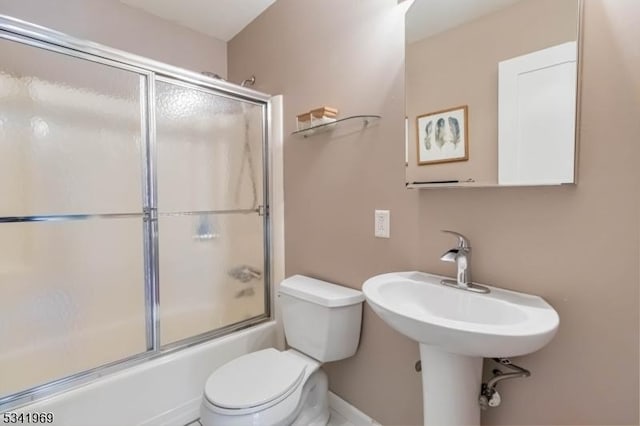 full bathroom with shower / bath combination with glass door and toilet