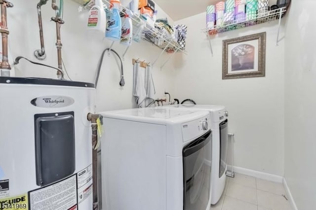 laundry room featuring laundry area, light tile patterned floors, baseboards, independent washer and dryer, and electric water heater