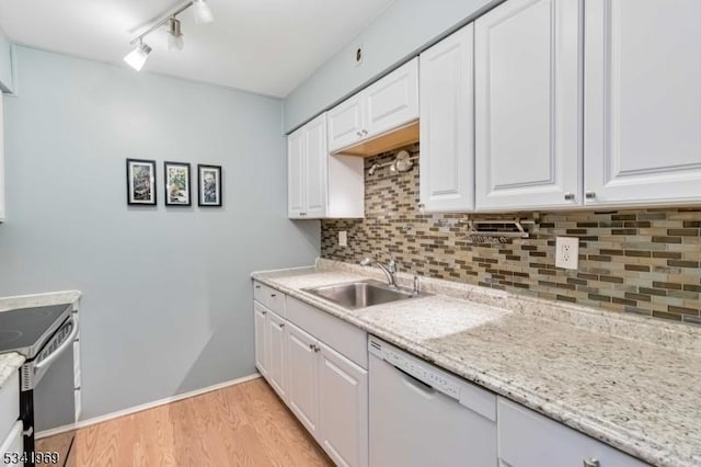 kitchen featuring tasteful backsplash, electric range, white cabinetry, a sink, and dishwasher