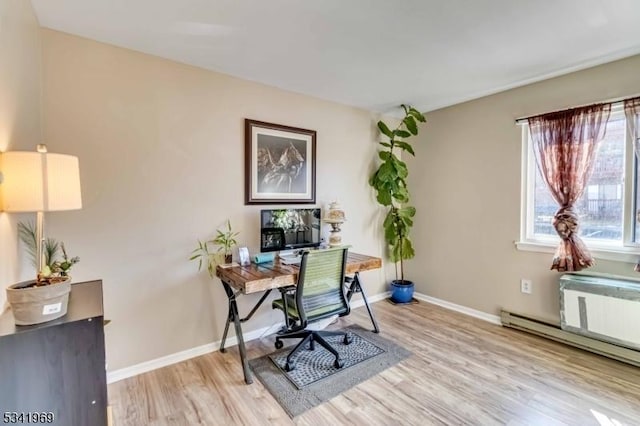 office area featuring baseboards, a baseboard heating unit, and light wood-style floors