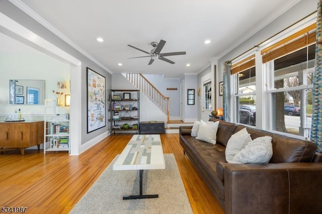 living area with recessed lighting, wood finished floors, stairs, and crown molding