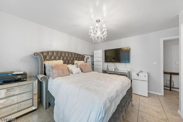 bedroom featuring a chandelier, freestanding refrigerator, baseboards, and light tile patterned floors